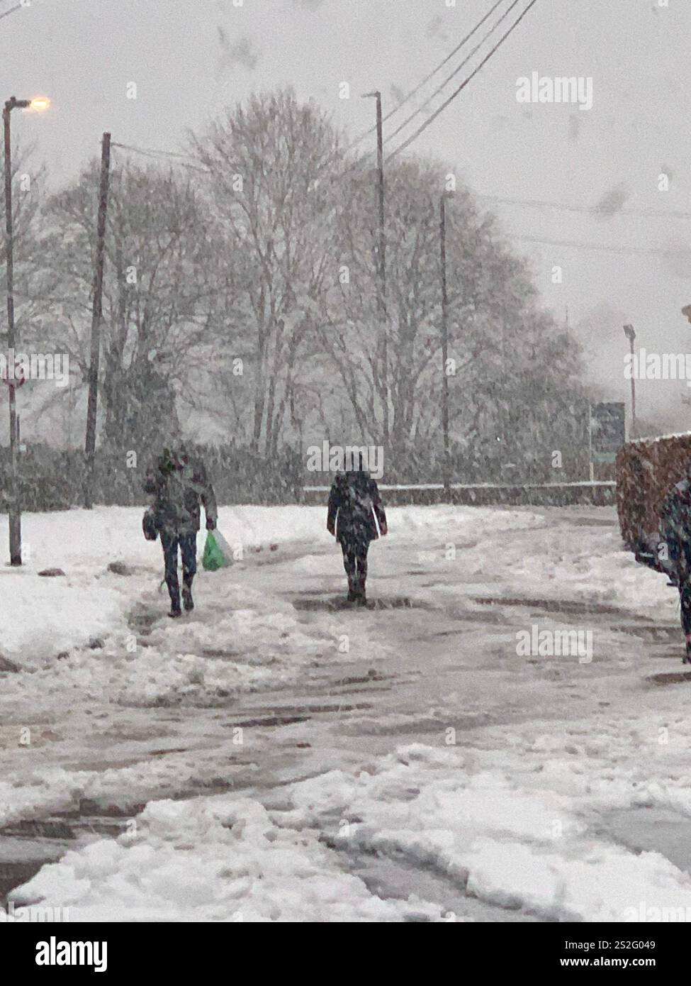Guiseley North Yorkshire snow ice Weather Christmas clearing clear drive driveway place Town home live lived snowing storm Airport sludge spade man UK - Smartphone Captured Stock Image