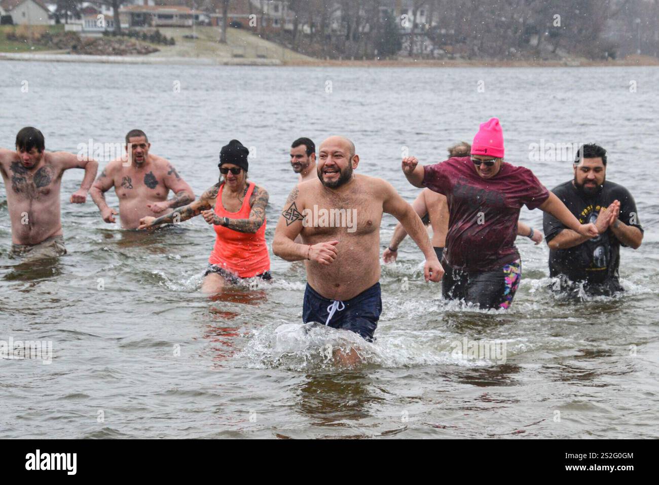 New Year's Day Polar Plunge participants dash through a chilly Stone ...
