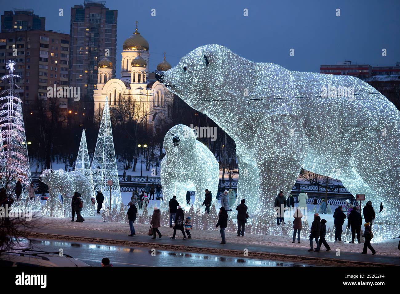 People walk and play at a park decorated for the New Year and Christmas festivities with an