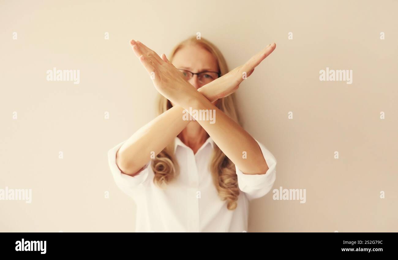Upset woman shows stop, no or enough sign with palm of hand, refusal ...