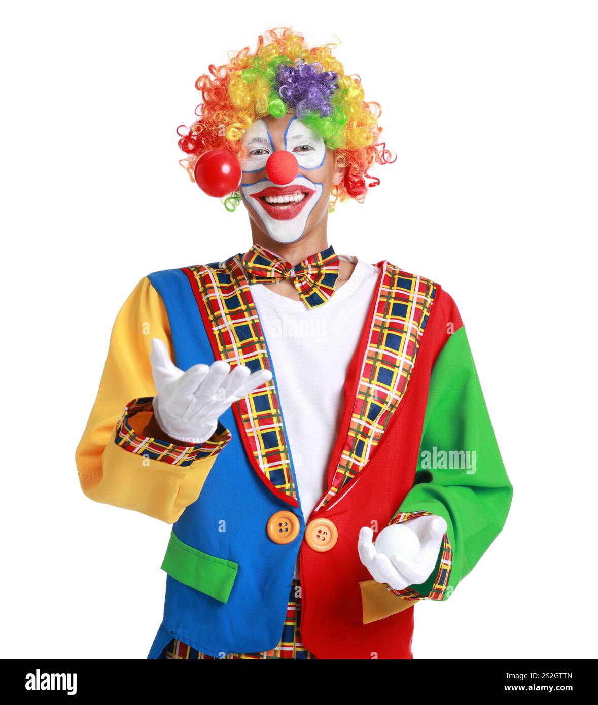 Happy clown juggling balls on white background Stock Photo - Alamy