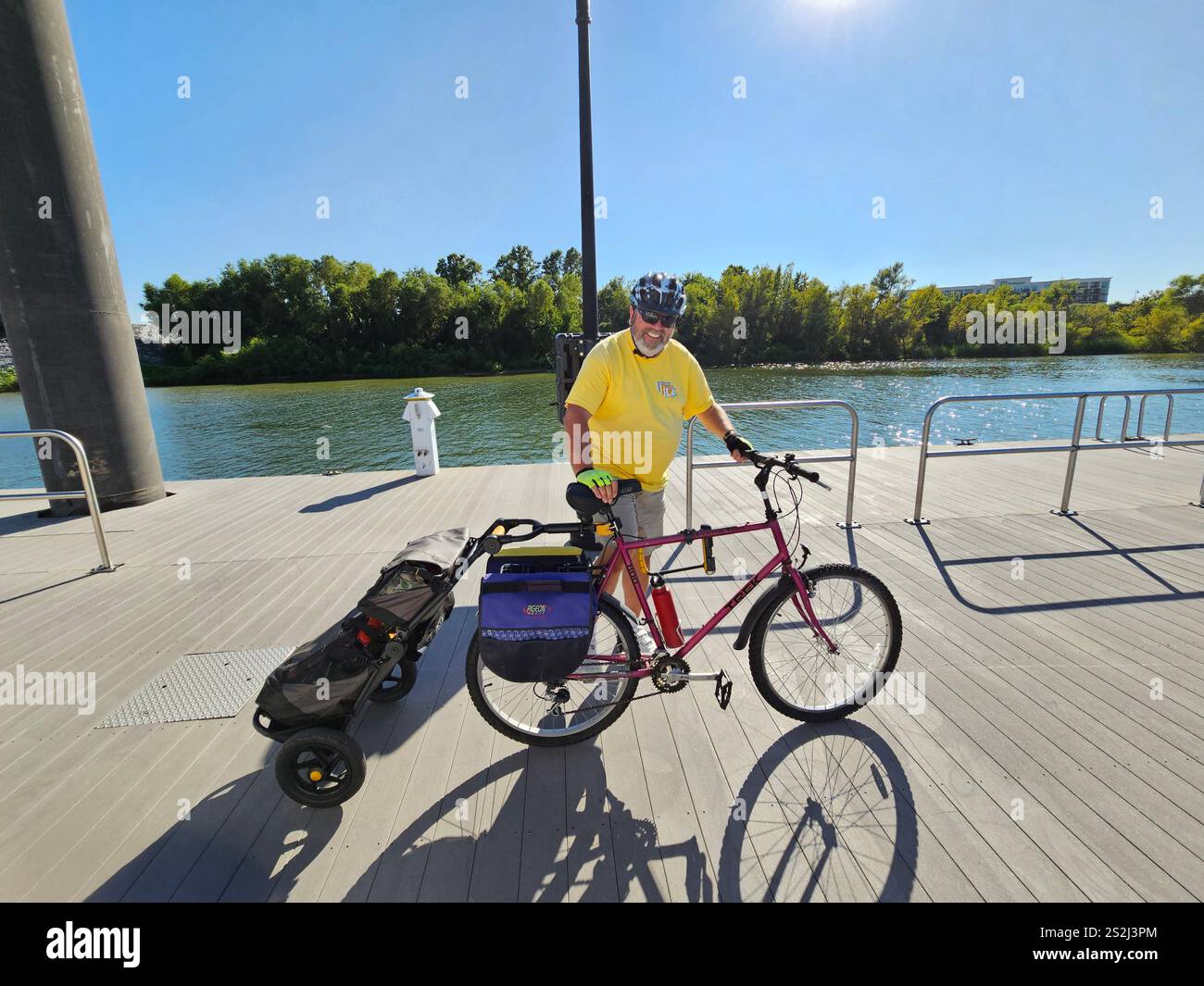 Man with a bicycle and cart on a dock after shopping for groceries. Stock Photo