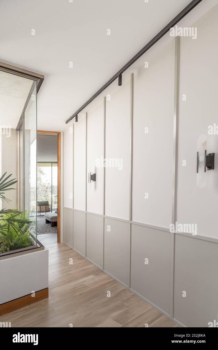 An elegant wooden hallway with built-in closets on each side ...