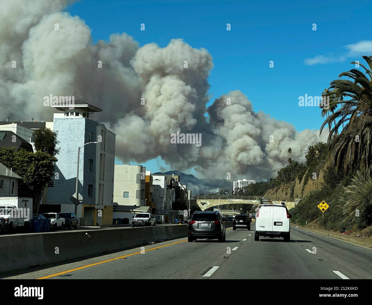 Heavy smoke from a brush fire in the Pacific Palisades rises over the