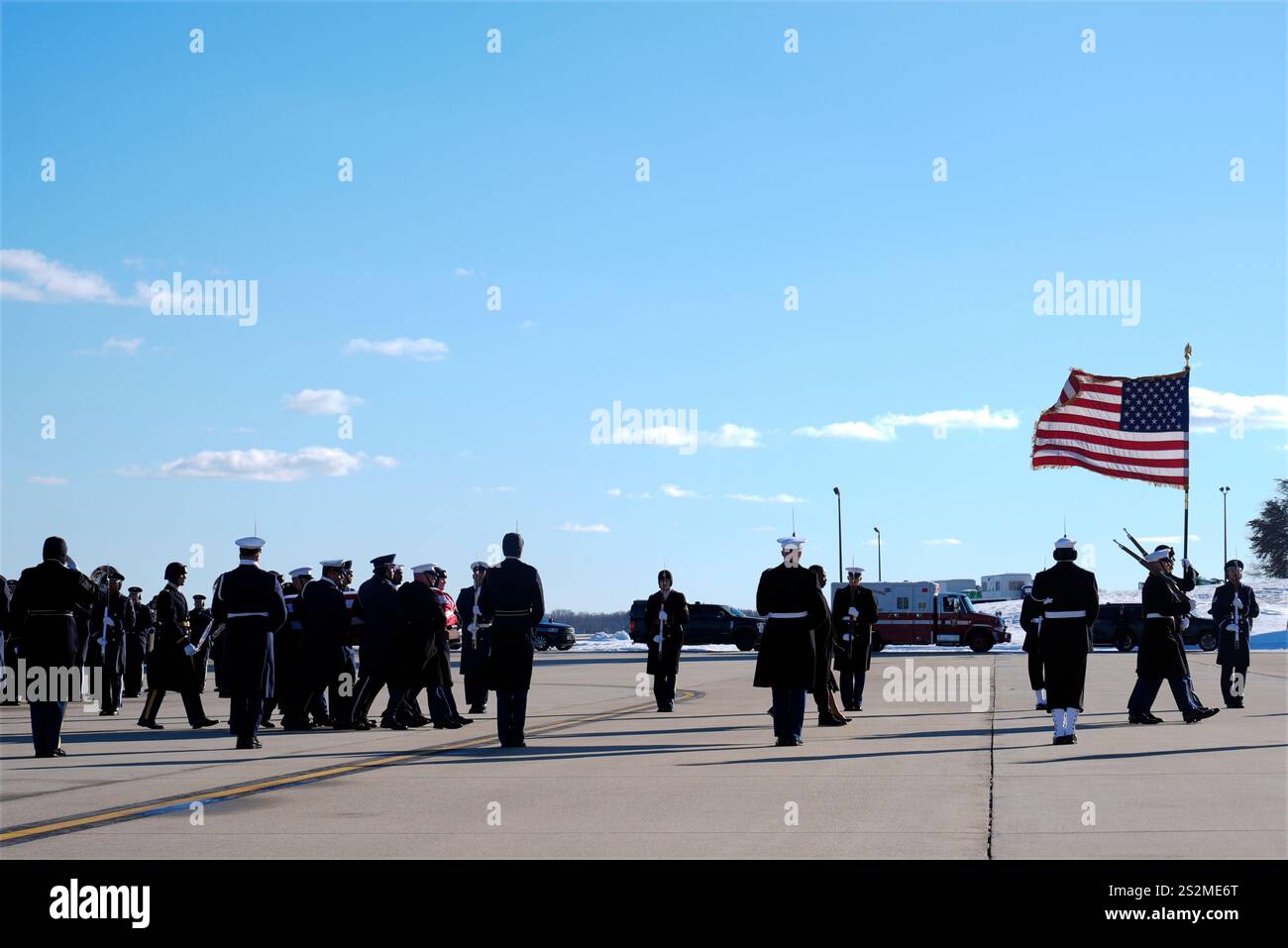 A joint forces body bearer team moves the flagdraped casket of former