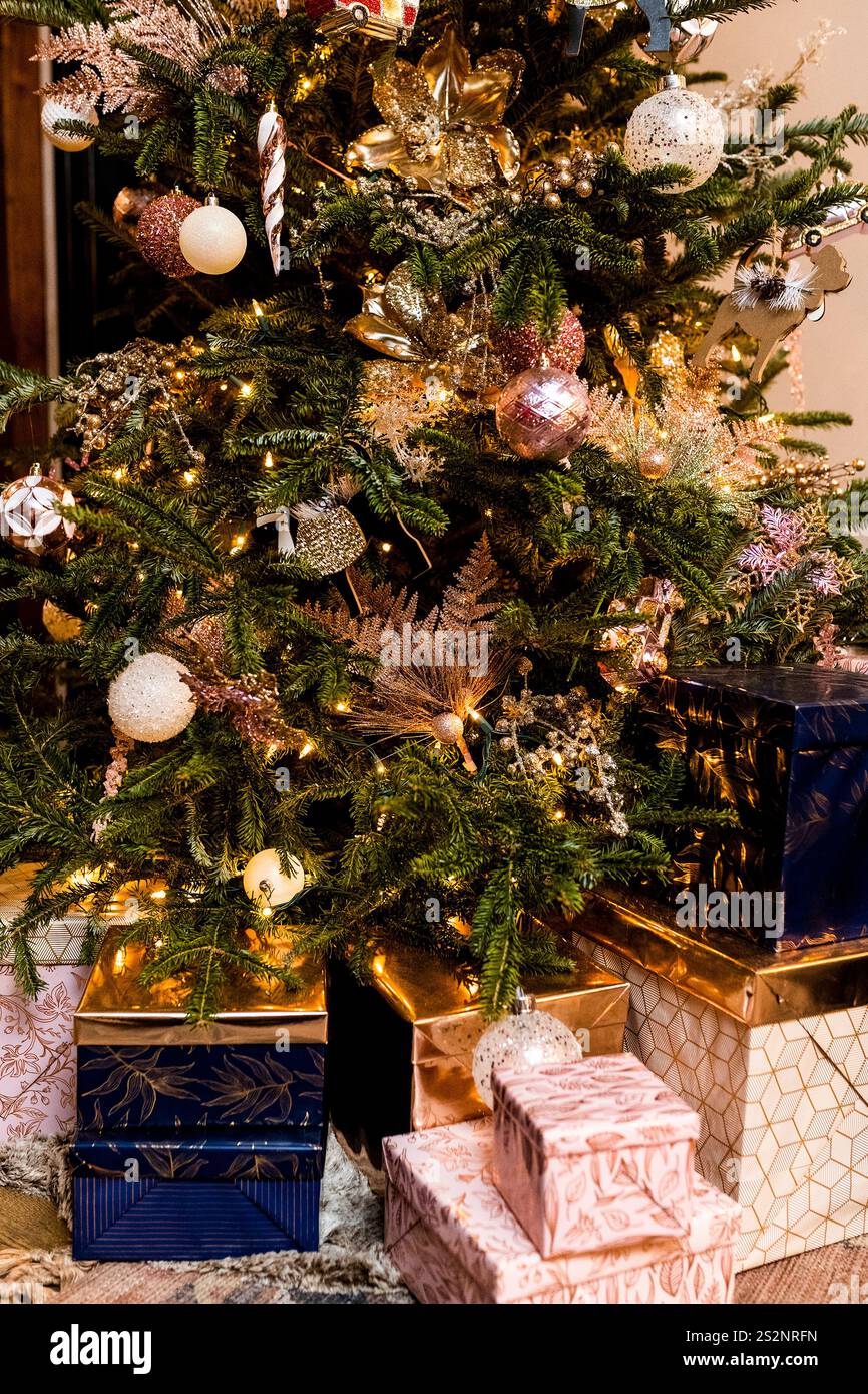 Wrapped gifts under decorated Christmas tree Stock Photo