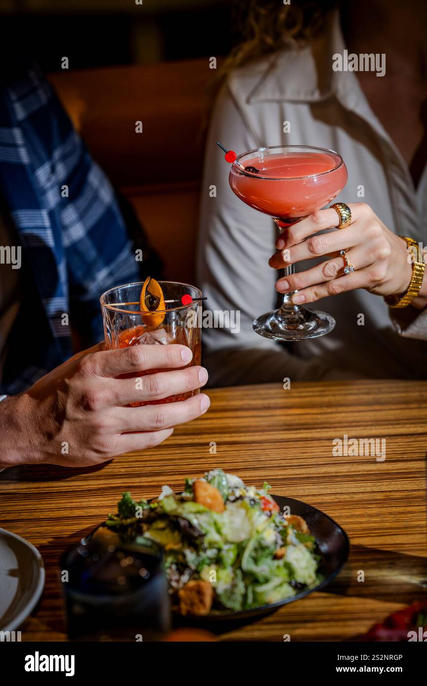 Hands holding cocktail glasses Stock Photo