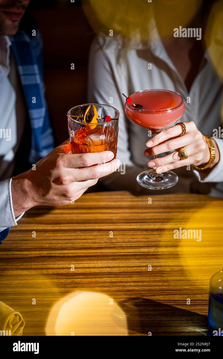 Hands holding cocktail glasses Stock Photo