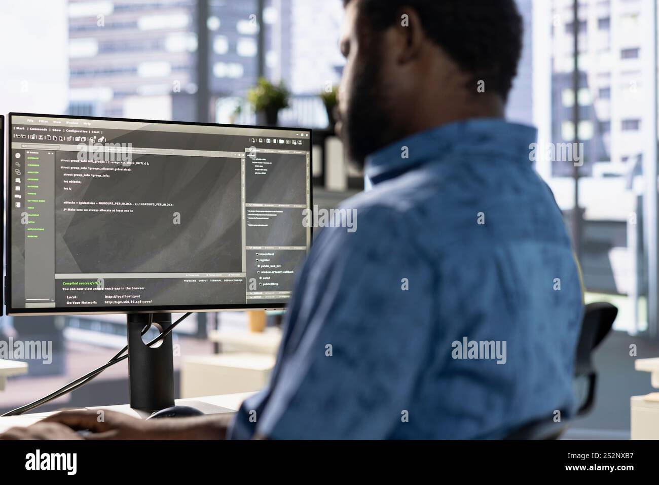System administrator debugging company software to minimize occurrence of bugs, identifying bottlenecks. African american man writing clean, efficient code in programming language to reduce errors Stock Photo