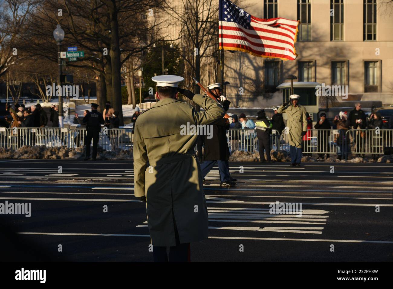 A member of the USMC Honor Guard salutes the flag during the funeral