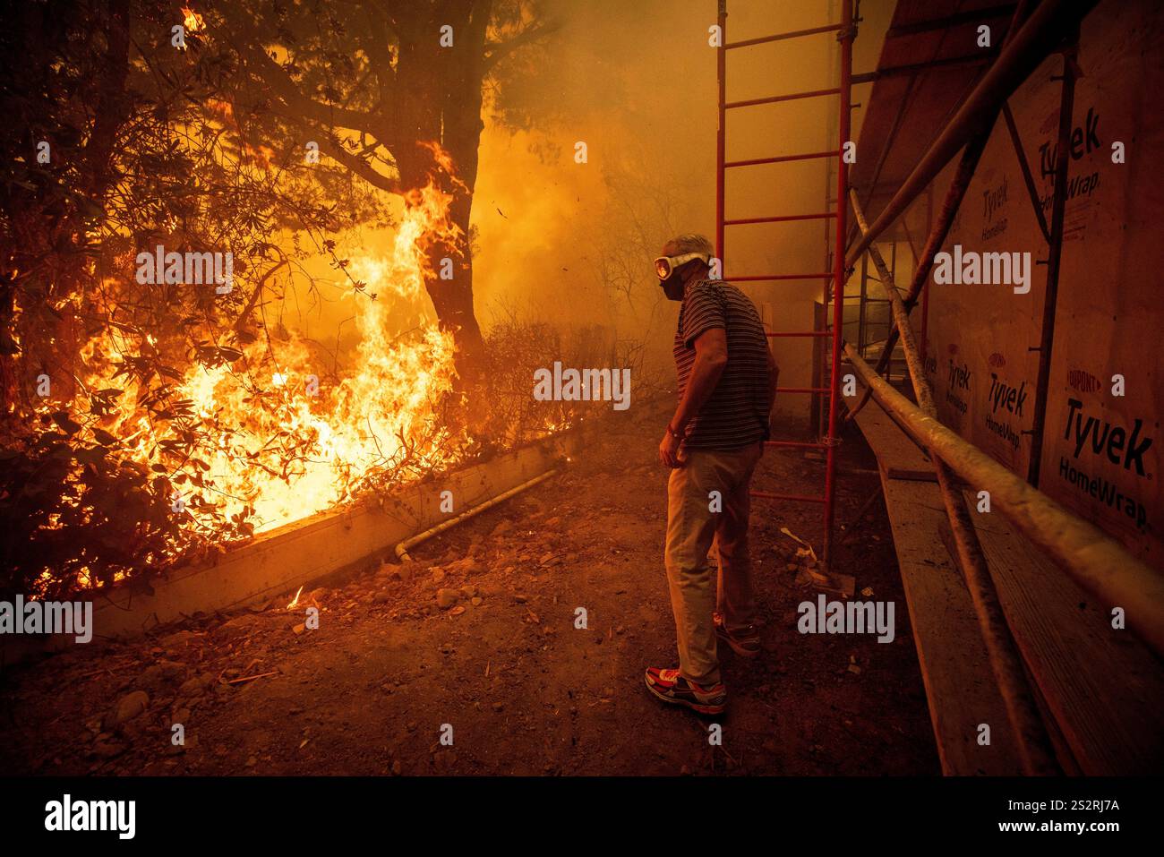 Will Adams watches as flames from the Palisades Fire close in on his