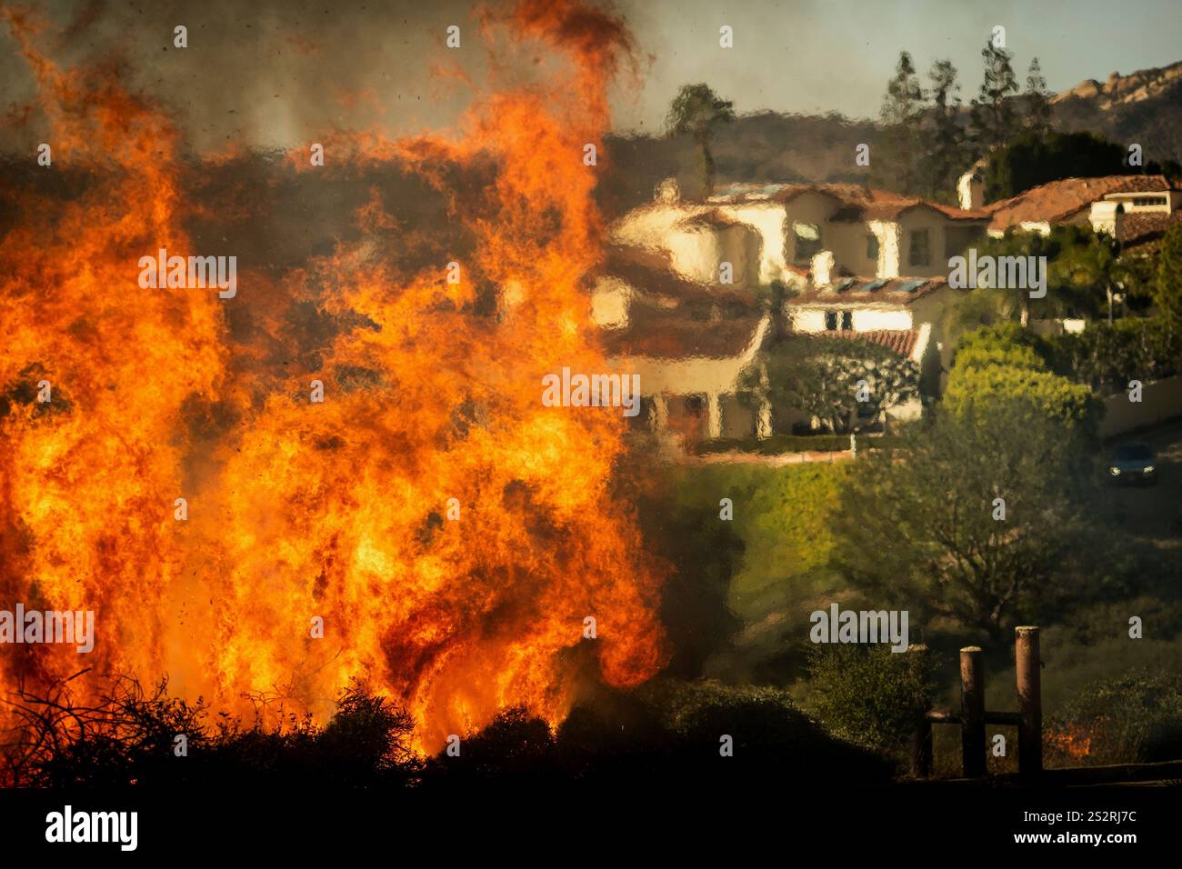 Flames rise as the Palisades Fire advances on homes in the Pacific