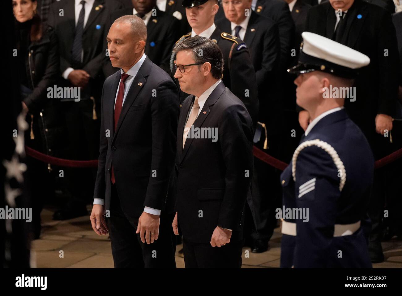 United States House Minority Leader Hakeem Jeffries (Democrat of New York), left, and Speaker of the US House of Representatives Mike Johnson (Republican of Louisiana), stand during a ceremony where former President Jimmy Carter lies in state in the Capitol, Tuesday, Jan. 7, 2025, in Washington. Carter died Dec. 29 at the age of 100. Credit: J. Scott Applewhite/Pool via CNP Stock Photo