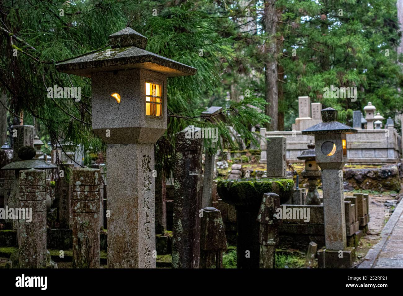 Koyasan cemetery in Japan. Amazing lanterns and atmosphere. Foggy trees. Ghibli inspiration Stock Photo