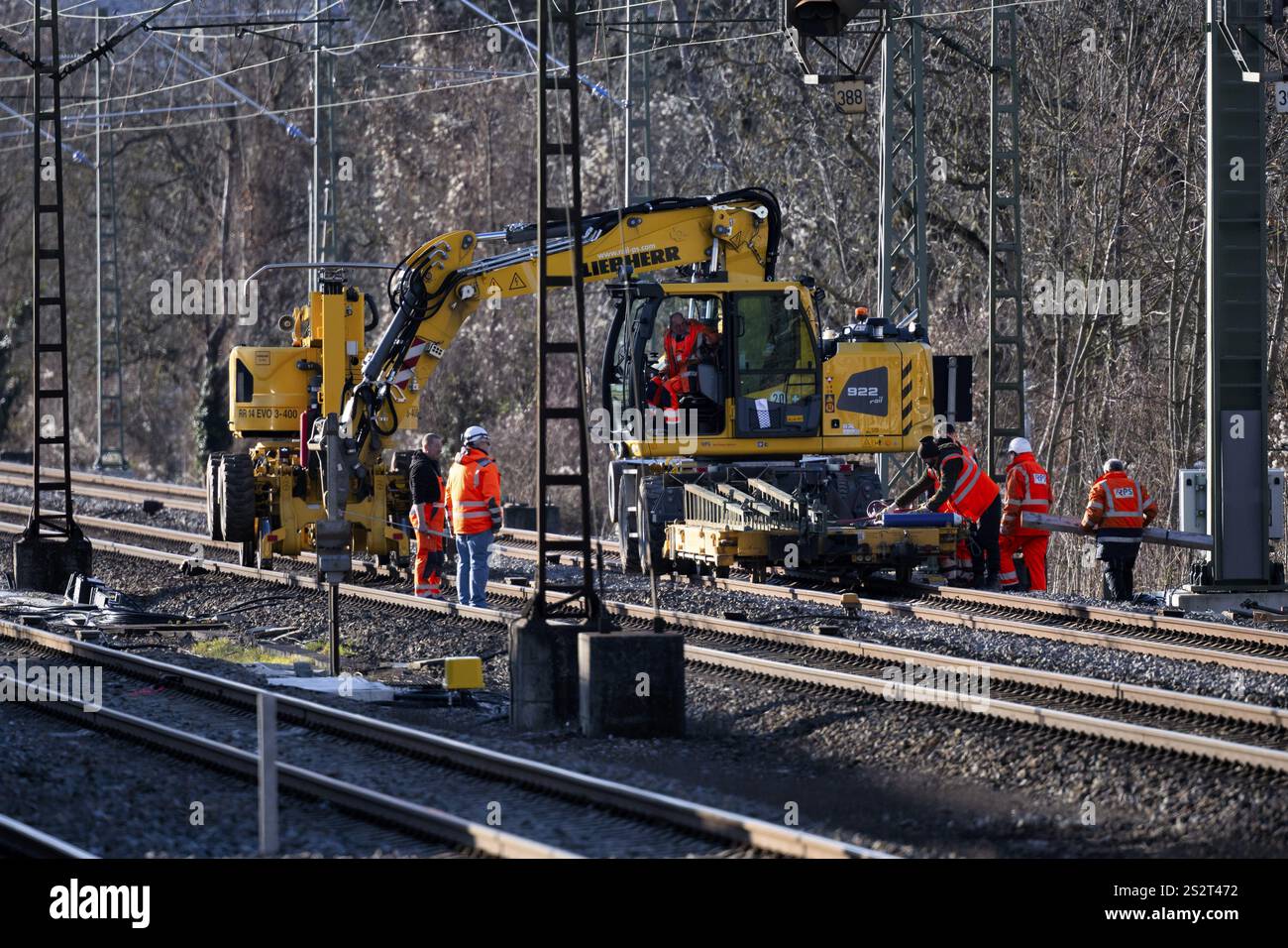 Labourers working with Liebherr A922 Rail Litronic and Kuhnle RR14 EVO 3 Rail two-way working platform on rails, line closure, construction site imple Stock Photo