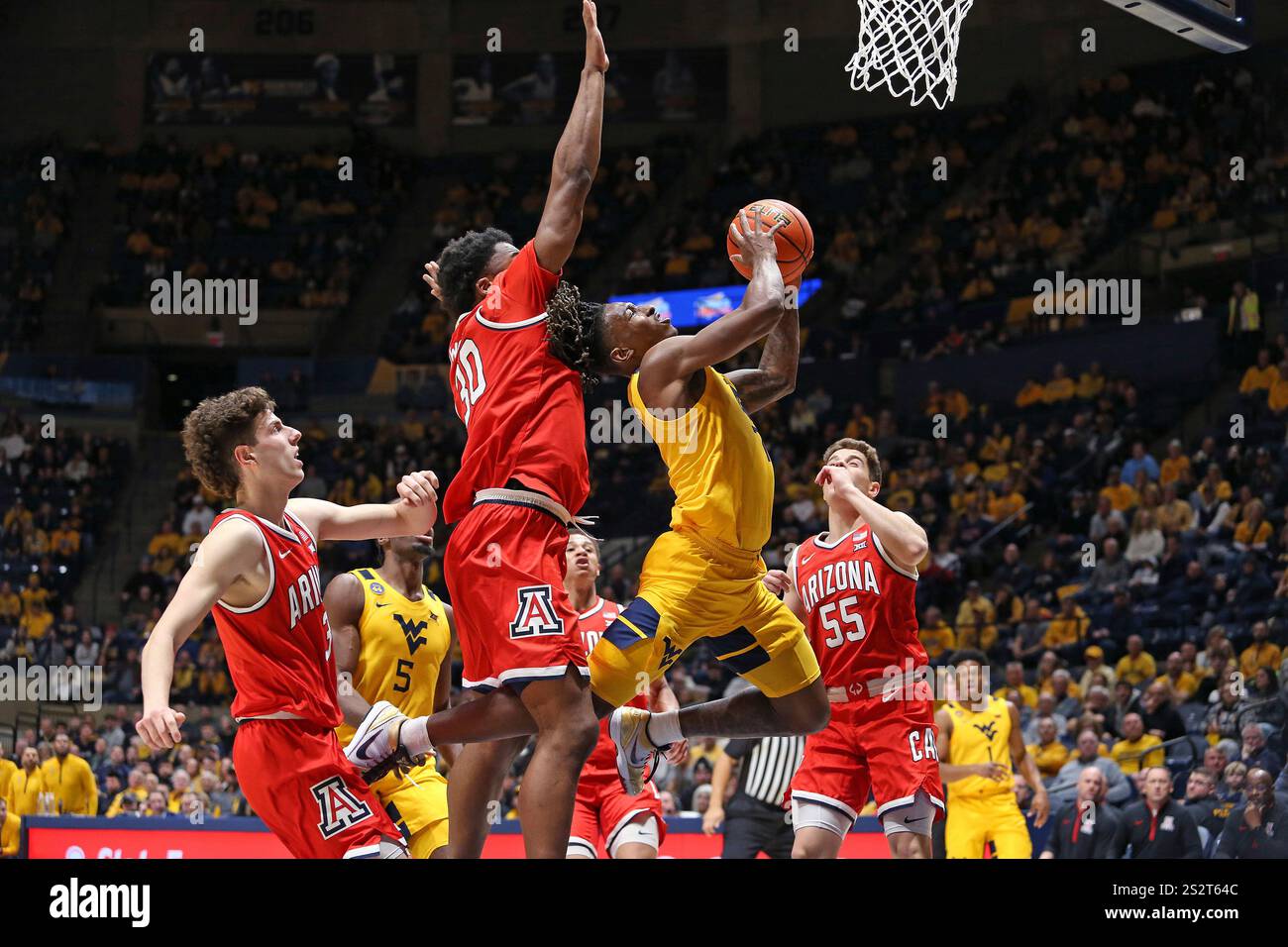West Virginia guard Javon Small (7) is defended by Arizona forward Tobe