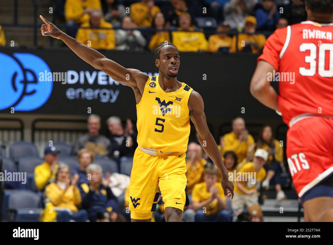 West Virginia guard Toby Okani (5) reacts during the first half of an