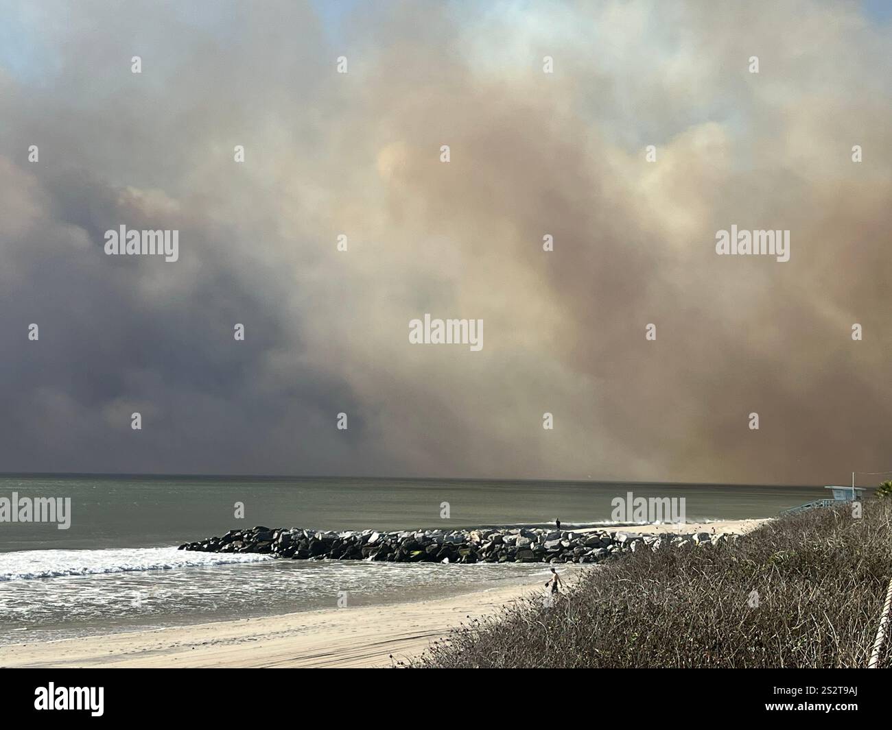 Palisades Fire, the beach bike path south of Sunset Blvd, smoke blowing out to ocean, Fire Department, LAPD staging areas on PCH, day one 1/7/2025. - Smartphone Captured Stock Image