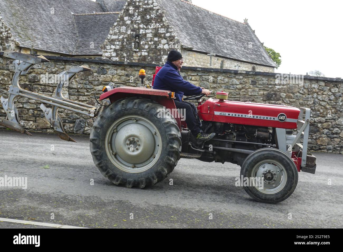 Old tractor Massey Ferguson 140 in front of church and chapel Sainte Nonne, vintage car meeting Dirinon, department Finistere Penn ar Bed, region Bret Stock Photo