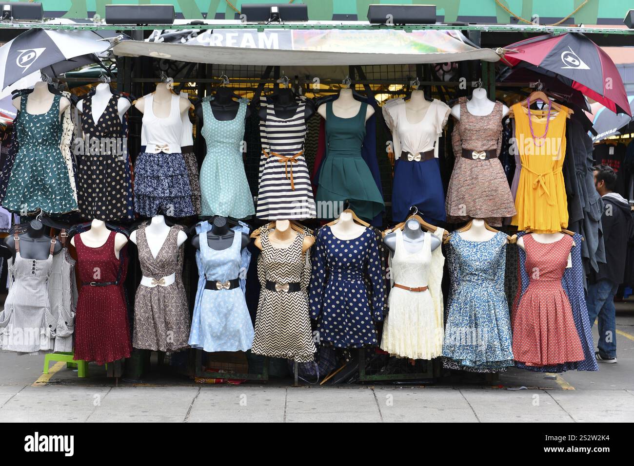 Dress stall, Camden Lock, Camden Town, London, London region, Market stall with colourful selection of summer dresses on mannequins, London, London re Stock Photo