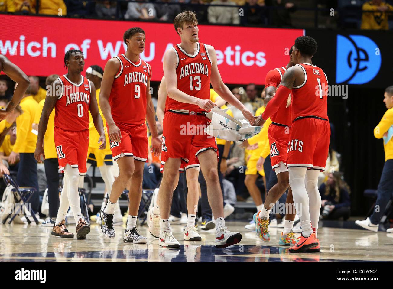 Arizona players meet on court during the second half of an NCAA college