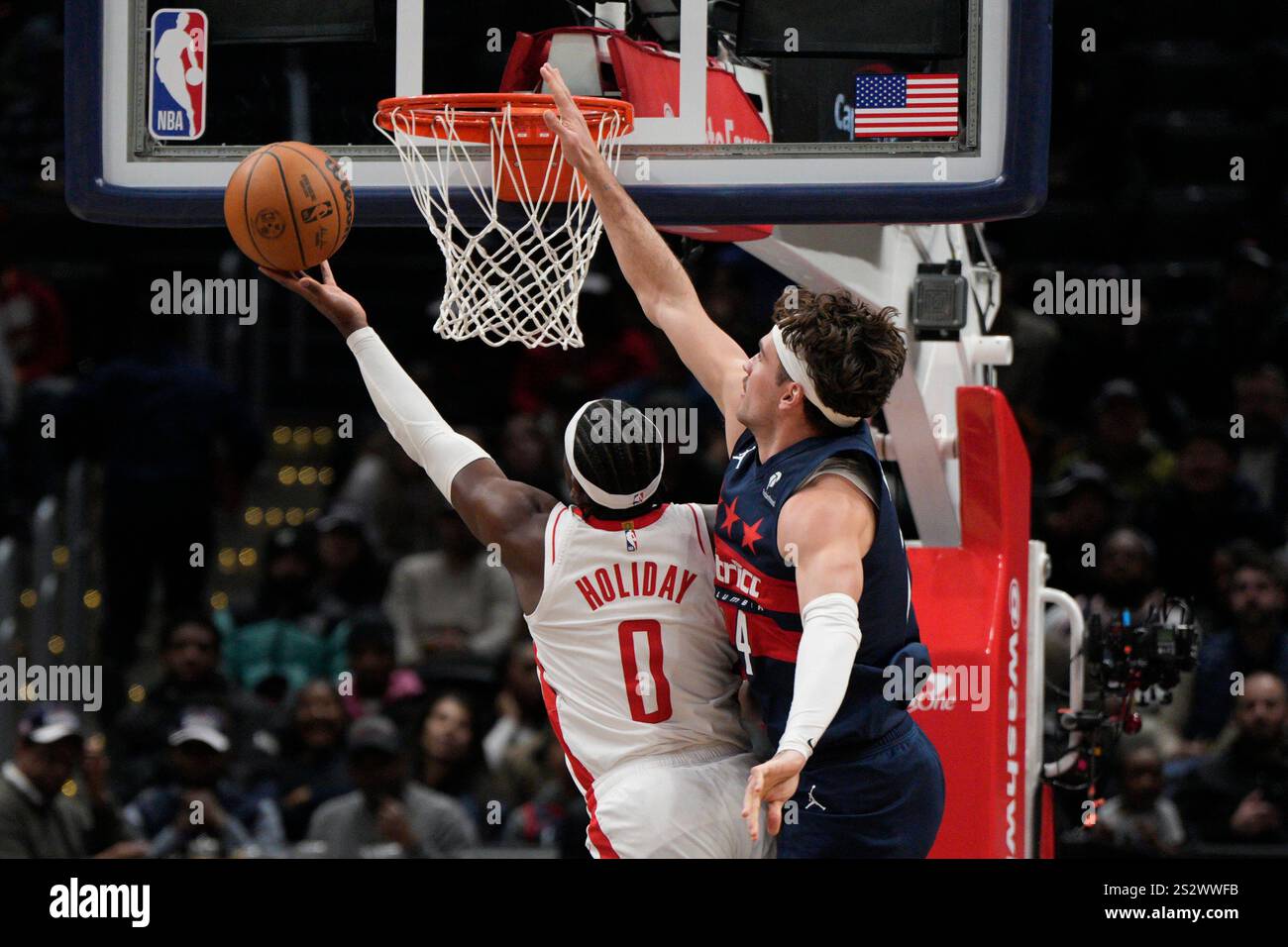 Houston Rockets guard Aaron Holiday (0) shoots the ball against