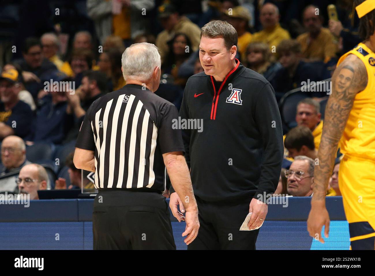 Arizona coach Tommy Lloyd speaks with an official during the first half