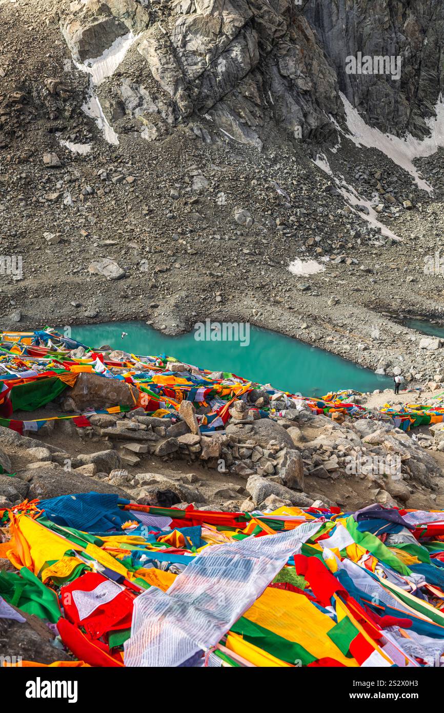 Tibetan praying flags at the Gauri Kund mountain lake during the ritual ...