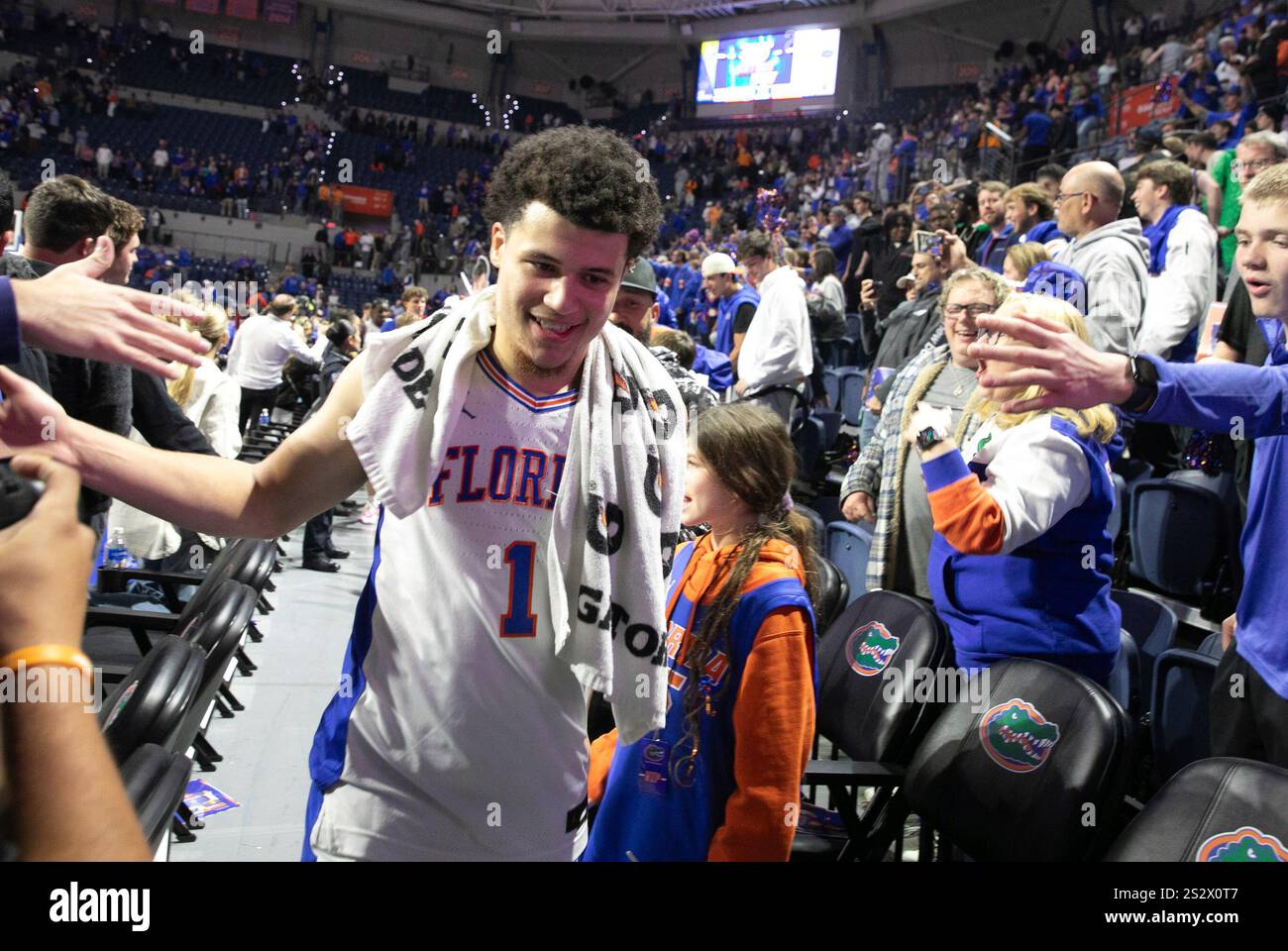 Florida guard Walter Clayton Jr. (1) celebrates with fans after