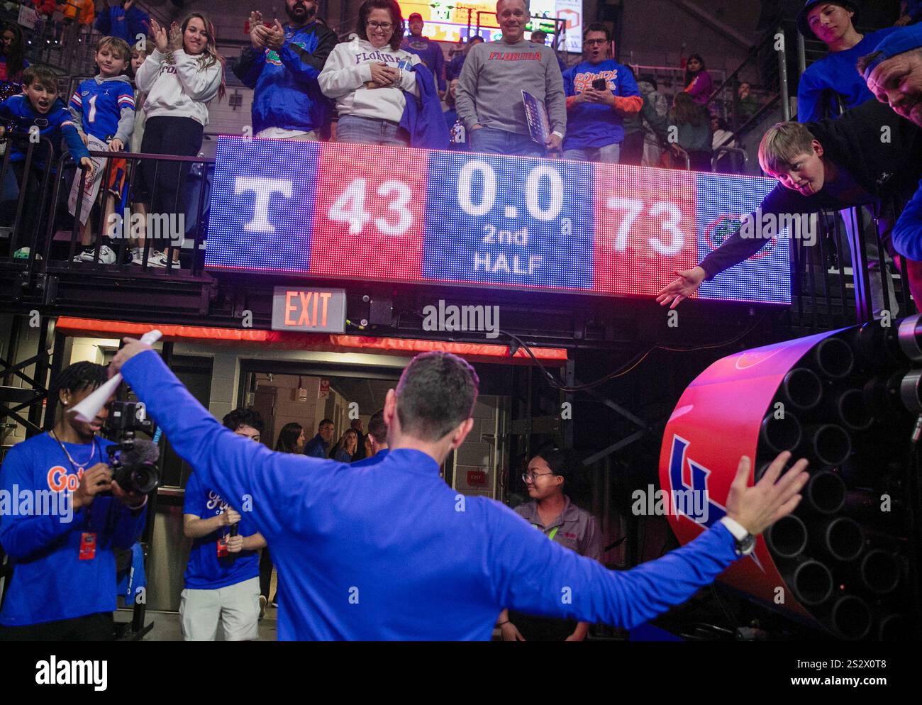 Florida head coach Todd Golden celebrates with fan after defeating