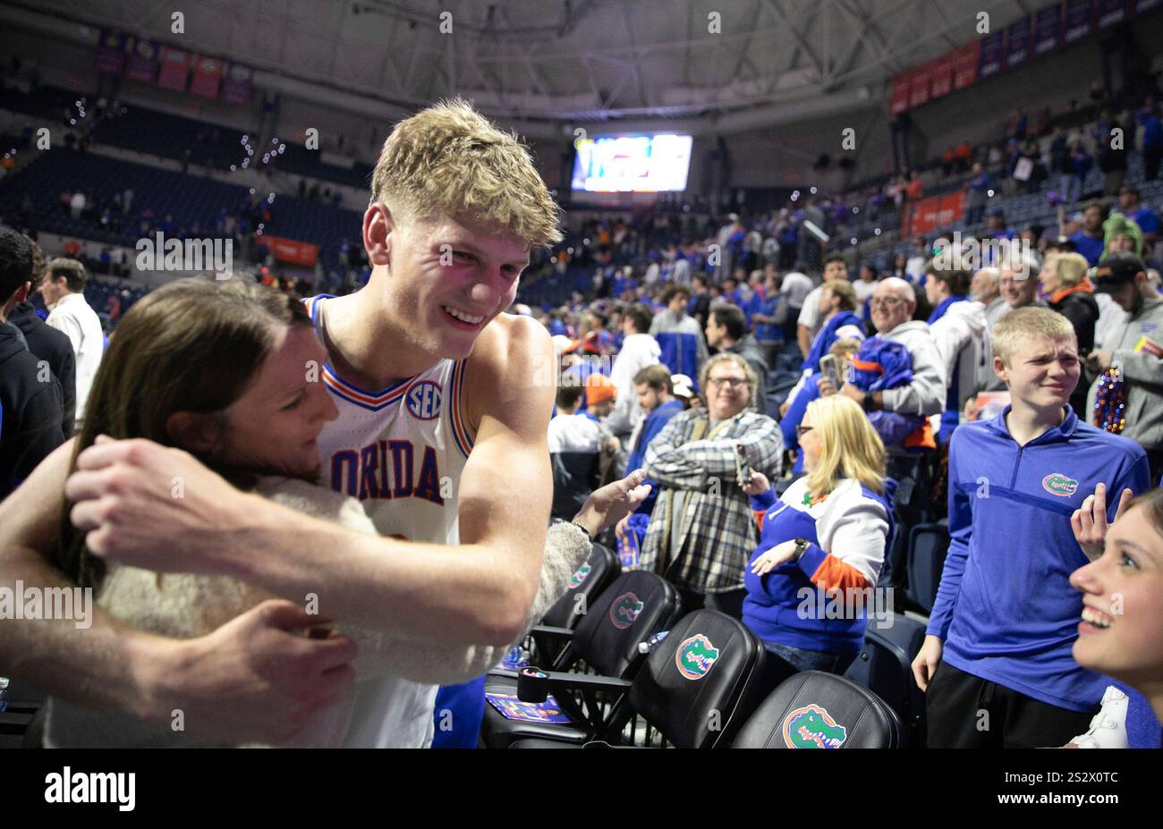 Florida forward Thomas Haugh, left, hugs a fan after defeating