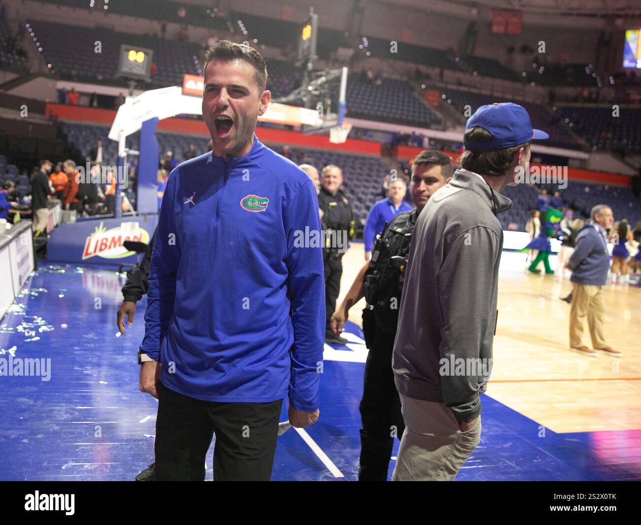 Florida head coach Todd Golden celebrates with fan after defeating