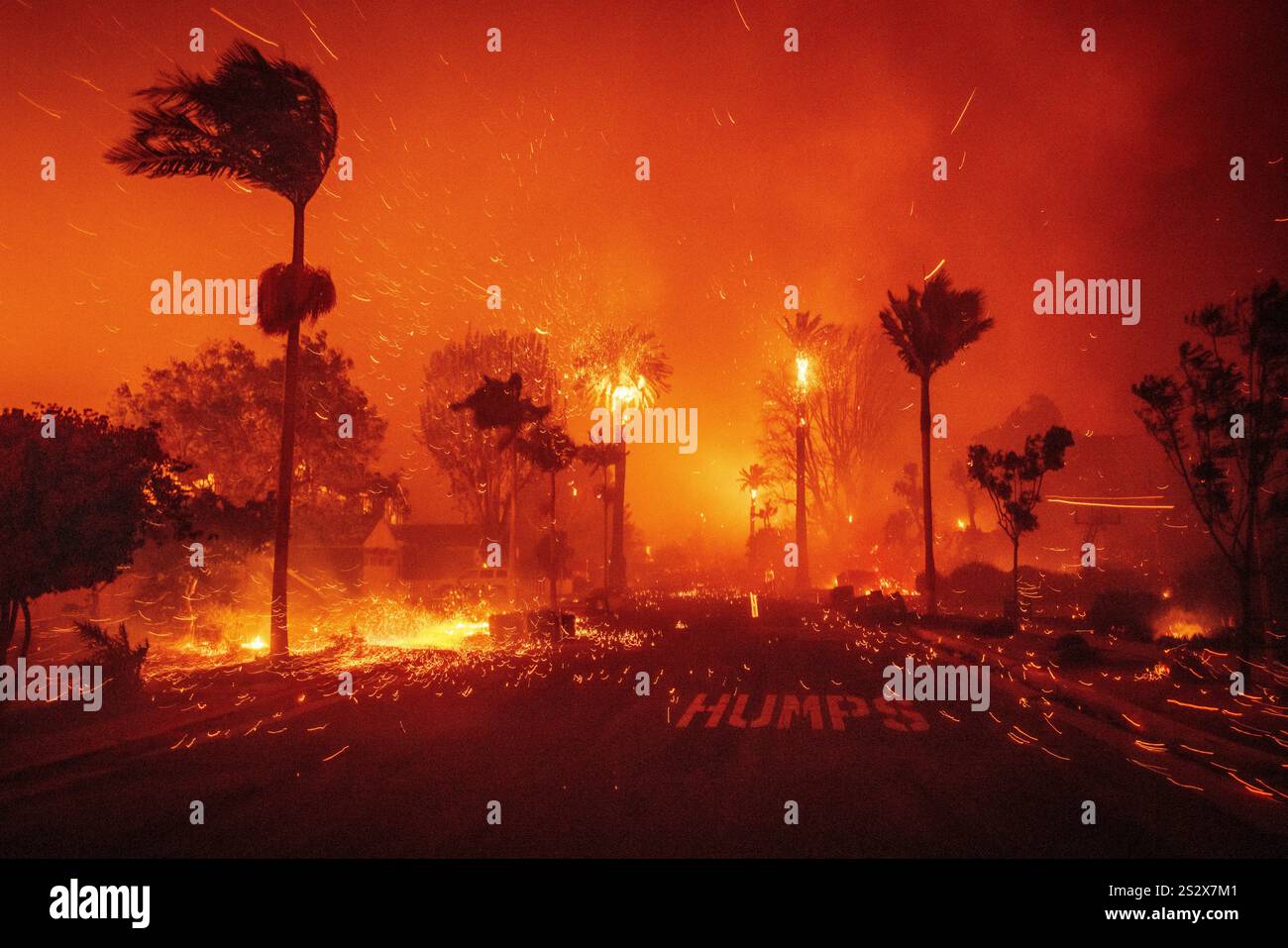 The Palisades Fire ravages a neighborhood amid high winds in the