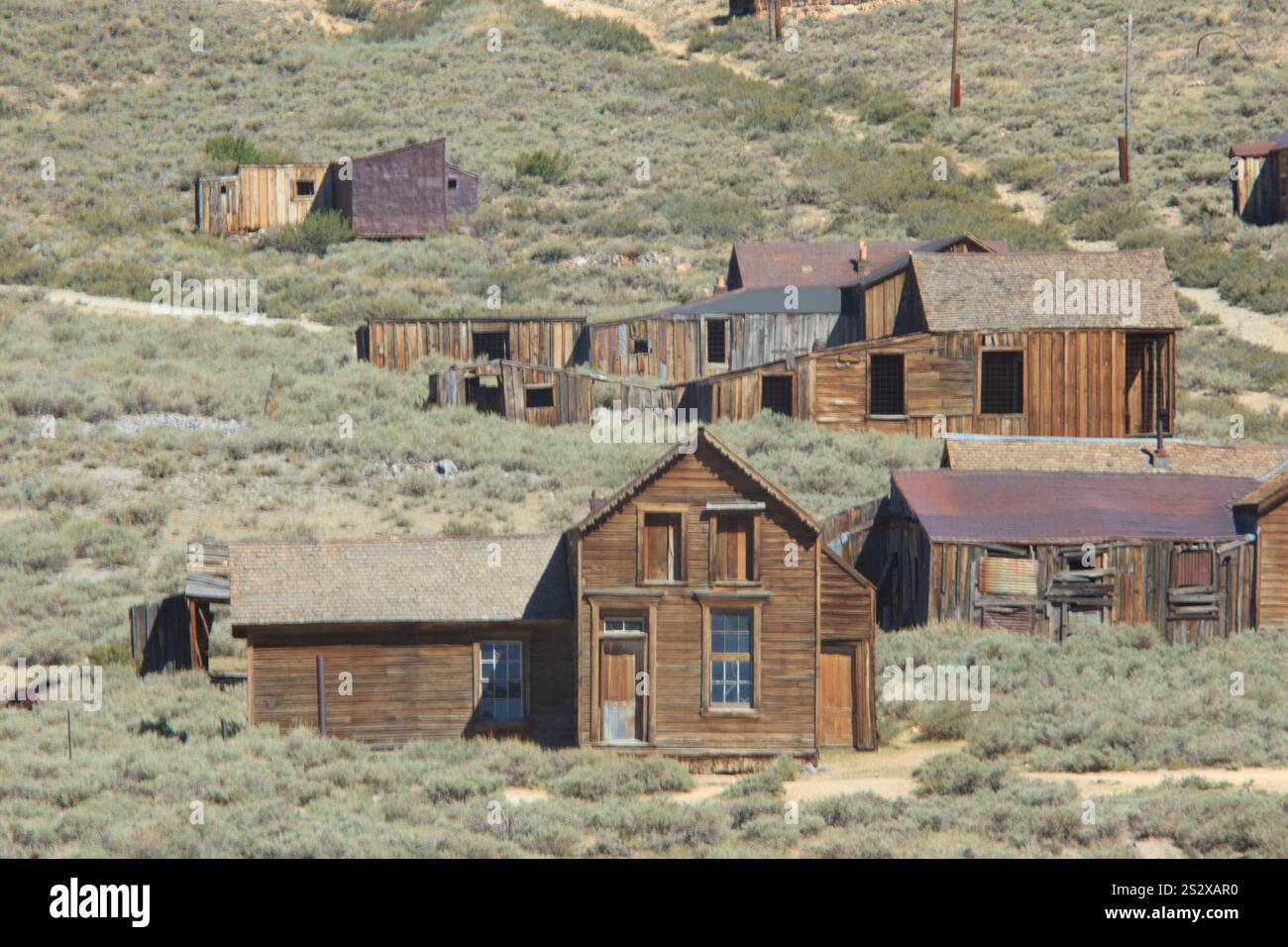 A small town with a few old buildings and a dirt road. The buildings ...