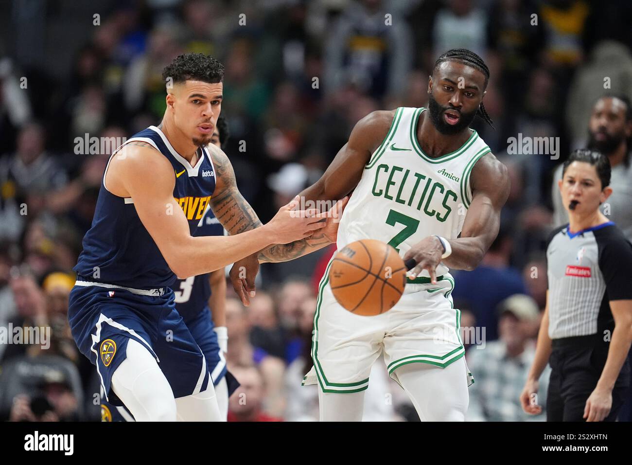 Boston Celtics guard Jaylen Brown, right, passes the ball as Denver