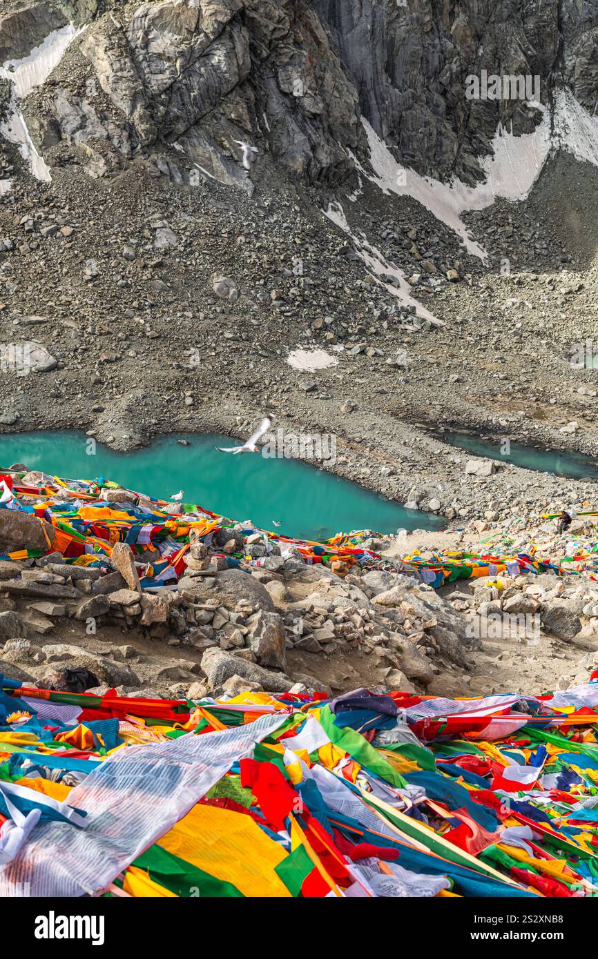 Tibetan praying flags at the Gauri Kund mountain lake during the ritual ...