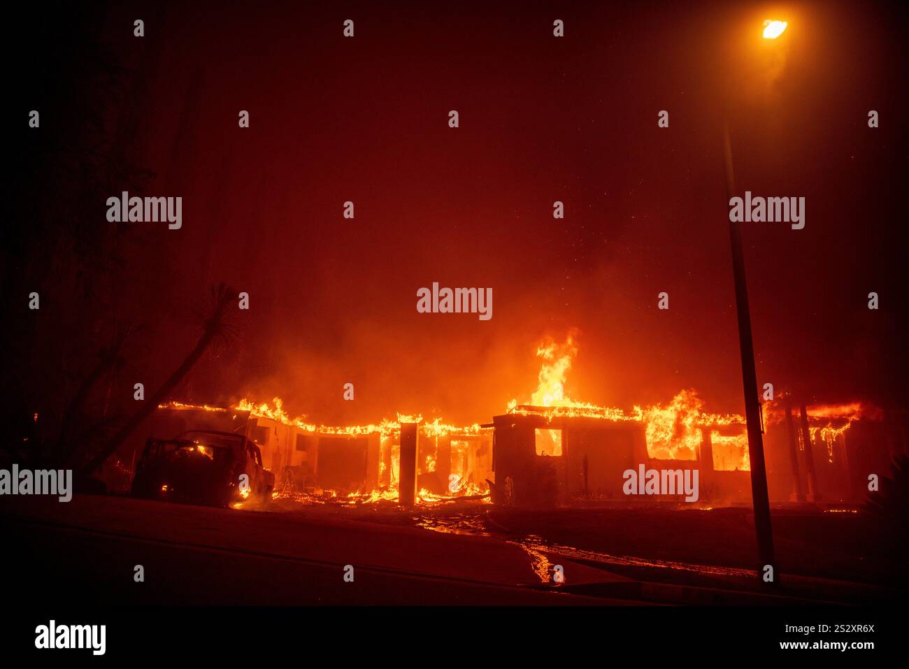 The Eaton Fire burns a structure Wednesday, Jan. 8, 2025 in Altadena