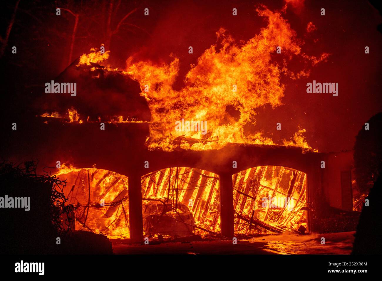 The Eaton Fire burns a residence Wednesday, Jan. 8, 2025 in Altadena