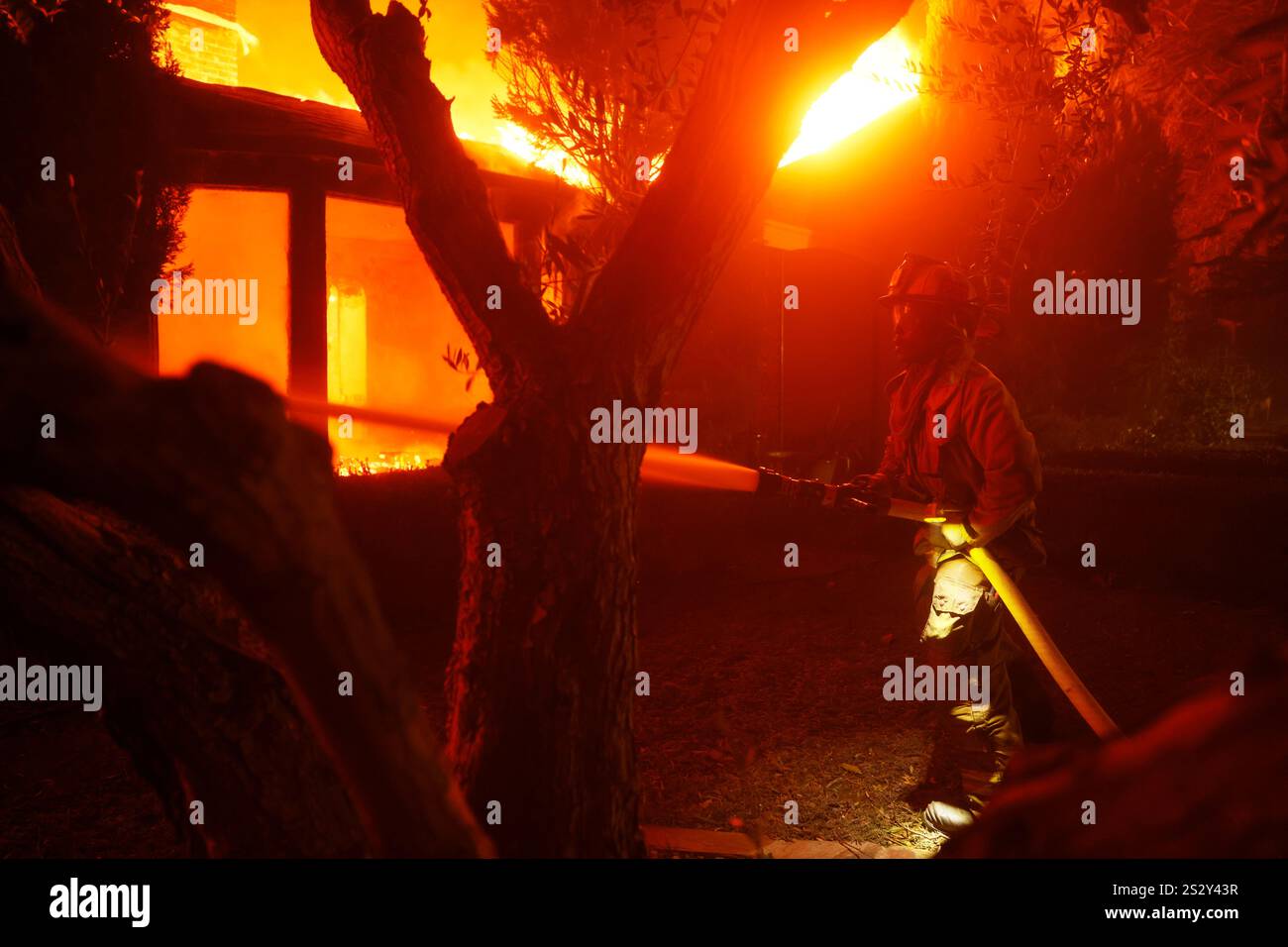 A firefighter battles the Palisades Fire in the Pacific Palisades