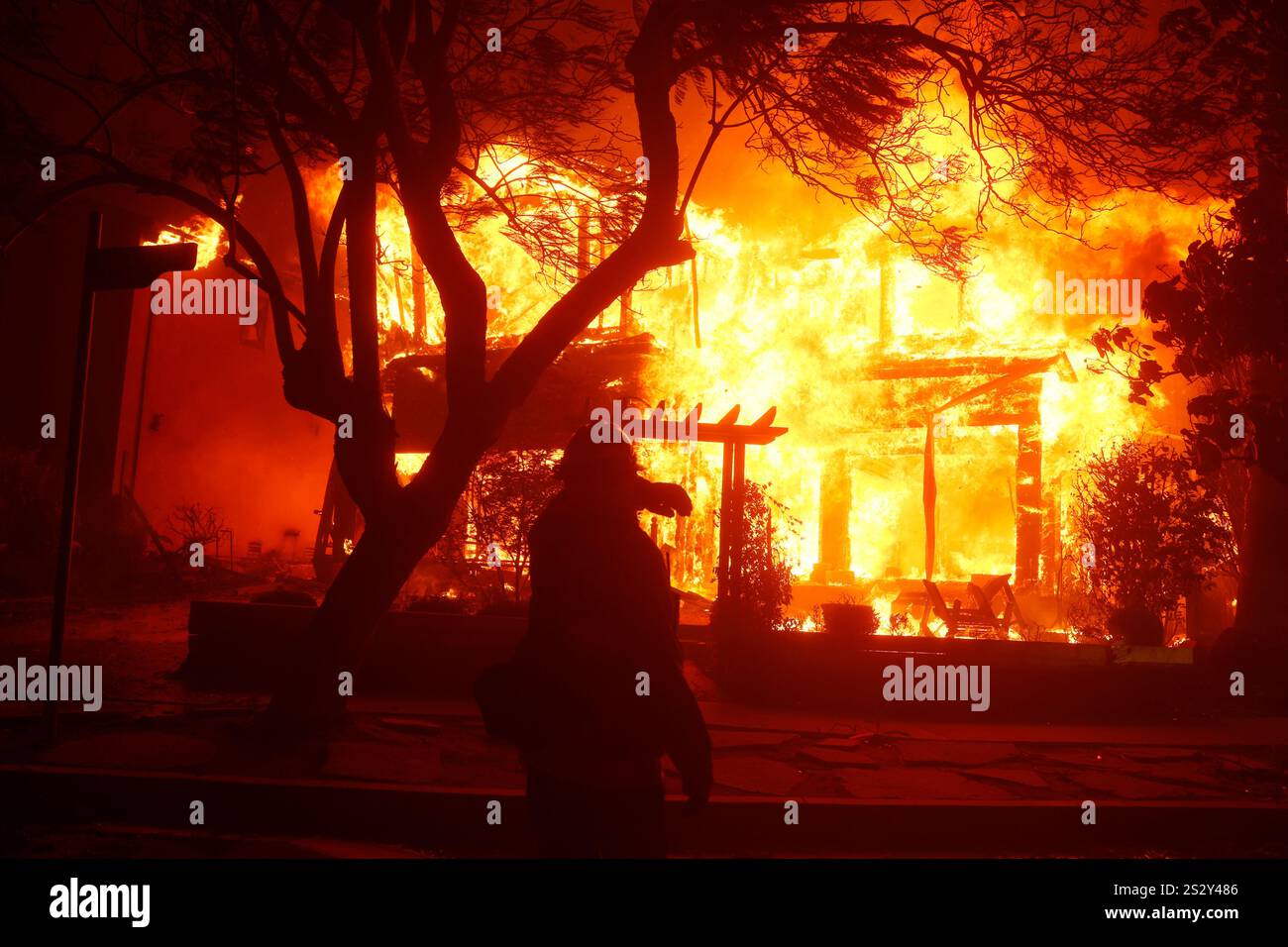 A firefighter battles the Palisades Fire in the Pacific Palisades