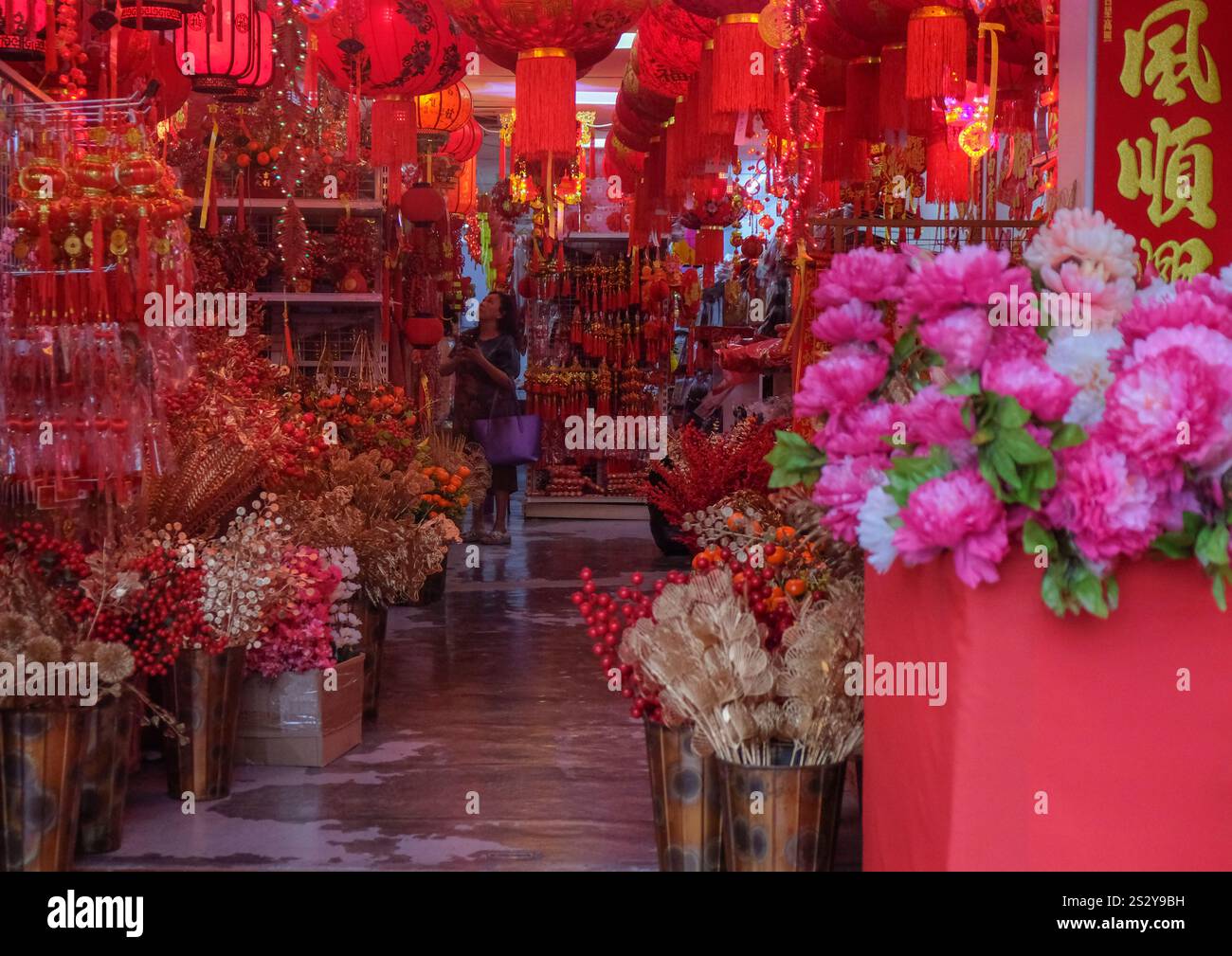 An ethnic Chinese woman shops decoration for the preparation of Chinese