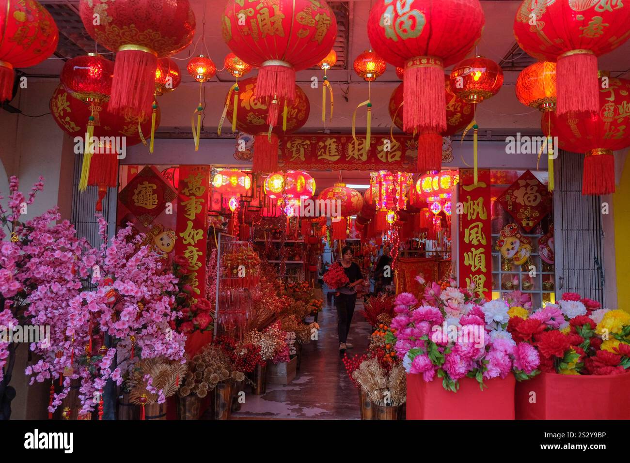 An ethnic Chinese woman shops decoration for the preparation of Chinese