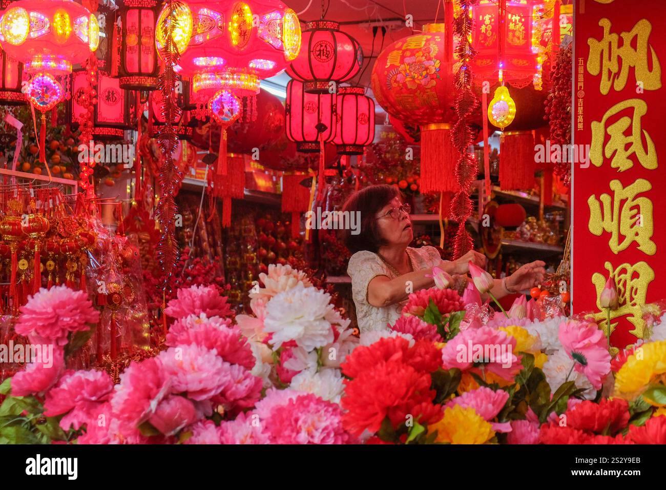 An ethnic Chinese woman shops decoration for the preparation of Chinese