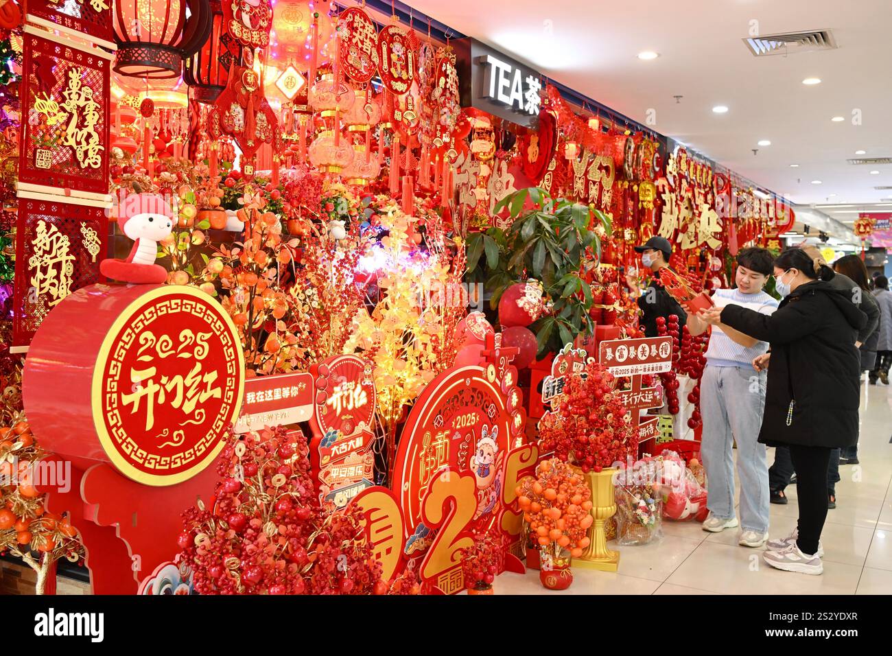 People select Spring Festival decorations at a market in Beijing, China