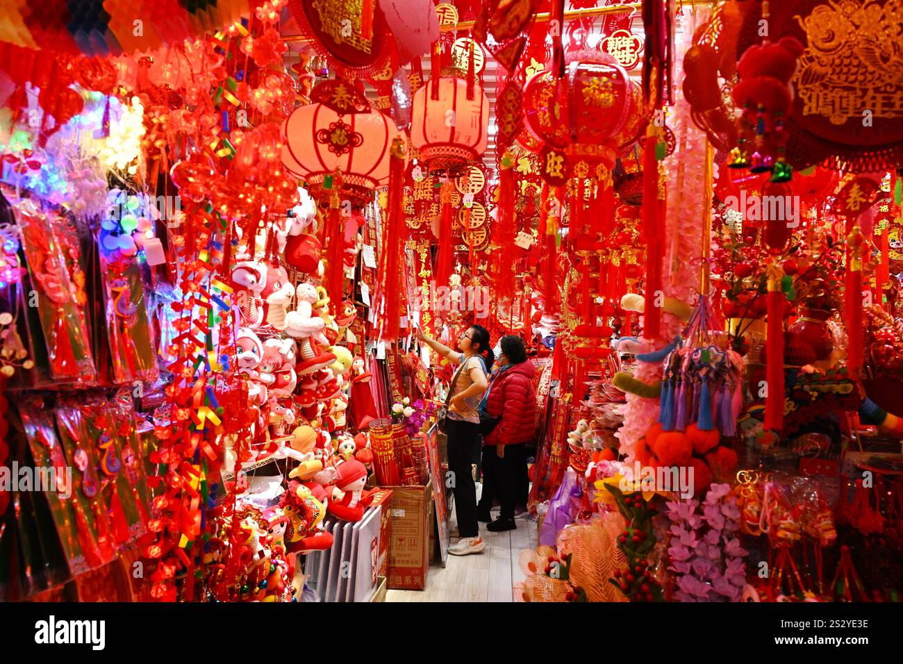 People select Spring Festival decorations at a market in Beijing, China