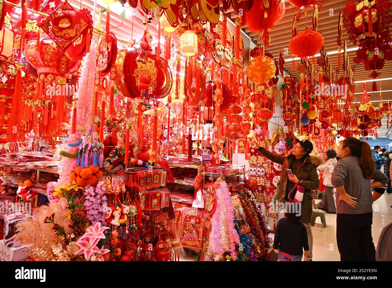 People select Spring Festival decorations at a market in Beijing, China