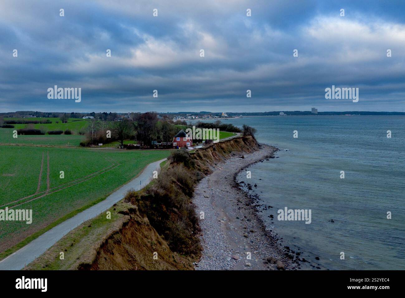 An abandoned house stands near the eroding bank of Brodten near
