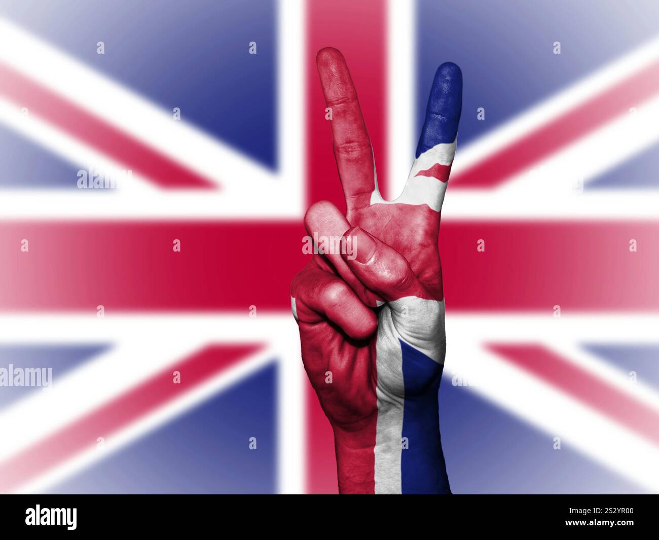 Male hand with victory sign in front of Great Britain flag Stock Photo