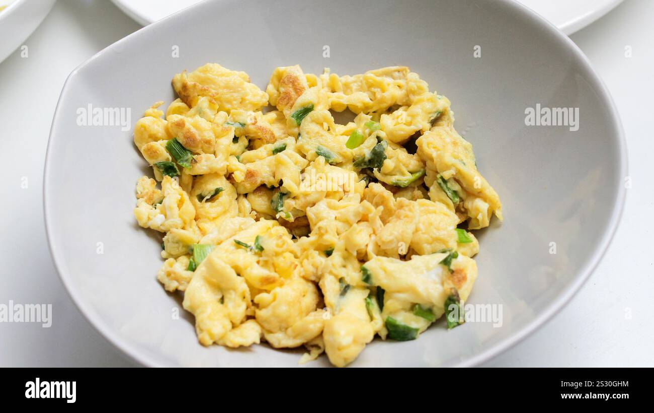 Scrambled eggs on white stone background. Close-up view Stock Photo