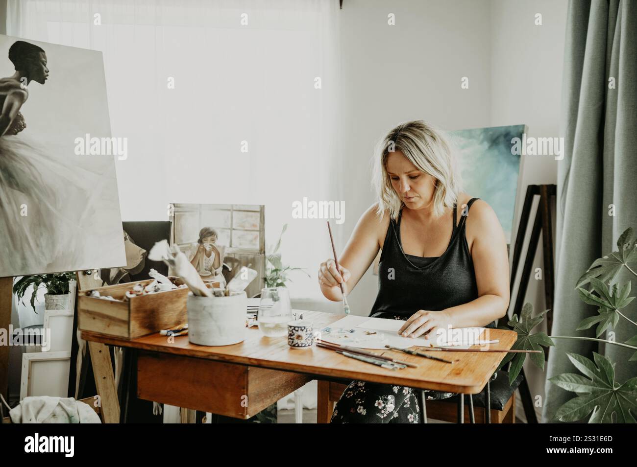 Creativity, studio and woman painting in her house on a canvas with ...